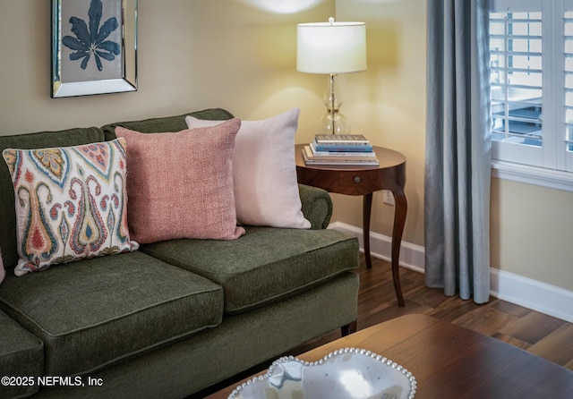 living area featuring a healthy amount of sunlight, baseboards, and wood finished floors