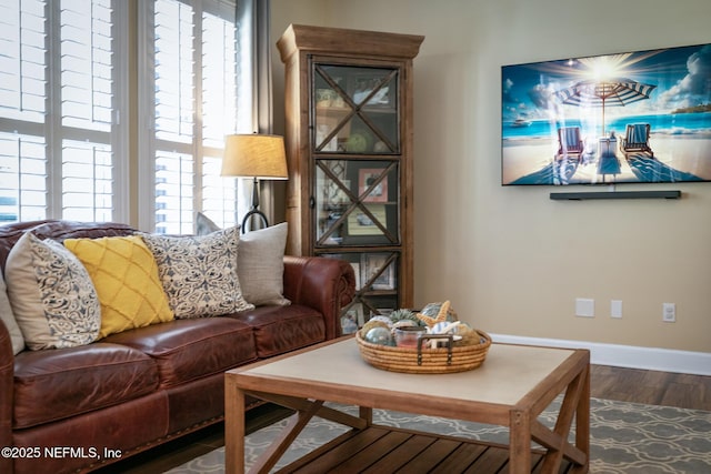 sitting room with wood finished floors and baseboards