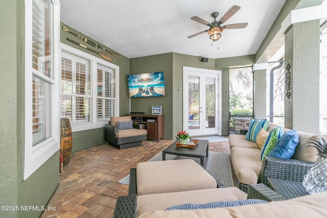 sunroom / solarium with french doors and ceiling fan