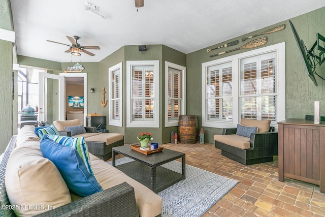 interior space with brick floor and ceiling fan