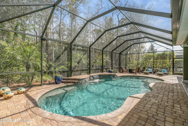 outdoor pool featuring a lanai and a patio area