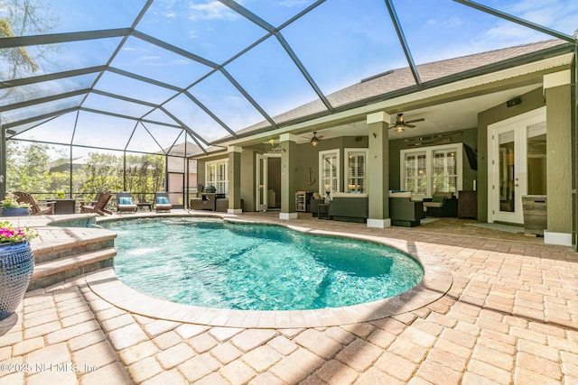 outdoor pool with glass enclosure, ceiling fan, french doors, a patio area, and outdoor lounge area