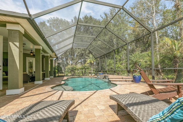 outdoor pool with a patio, a lanai, and a ceiling fan