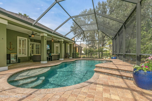 pool with a ceiling fan, french doors, a patio area, and a lanai