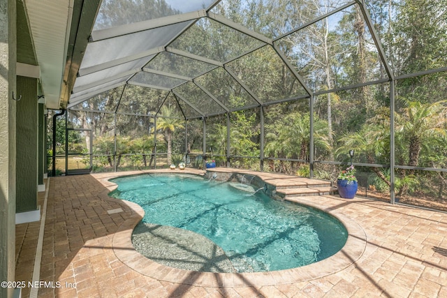 outdoor pool featuring a lanai and a patio area