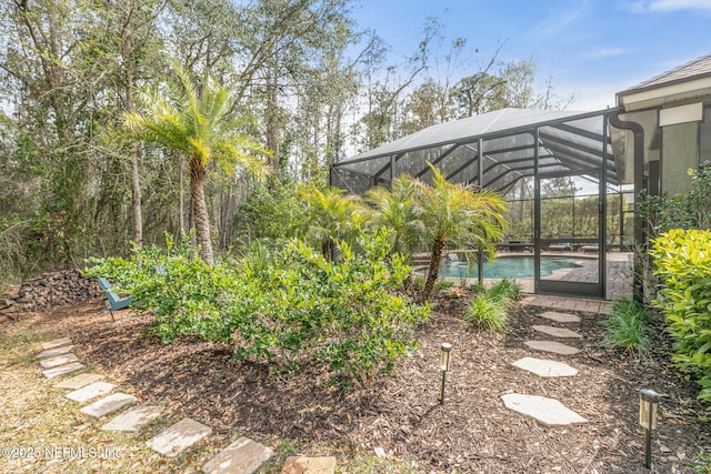 view of yard with a lanai and an outdoor pool