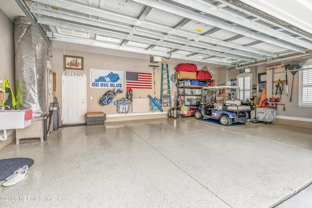 garage with baseboards and a garage door opener