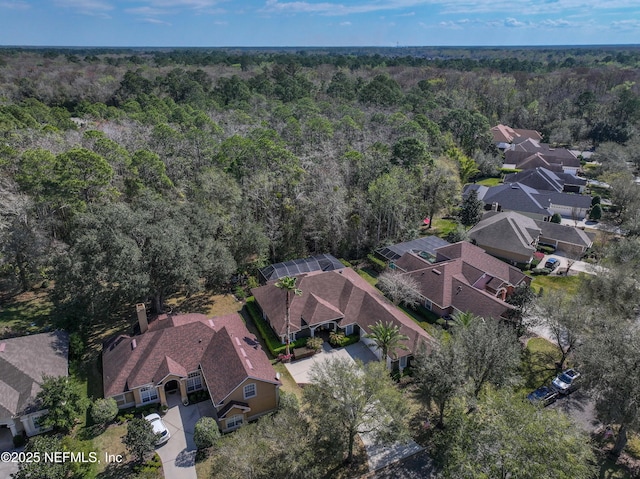 birds eye view of property with a residential view and a wooded view