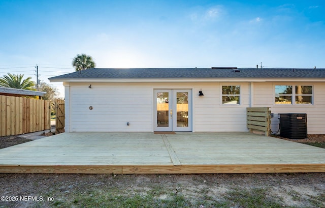 rear view of house with cooling unit, fence, and a deck