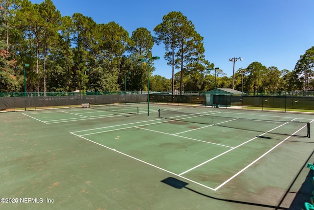 view of sport court featuring fence