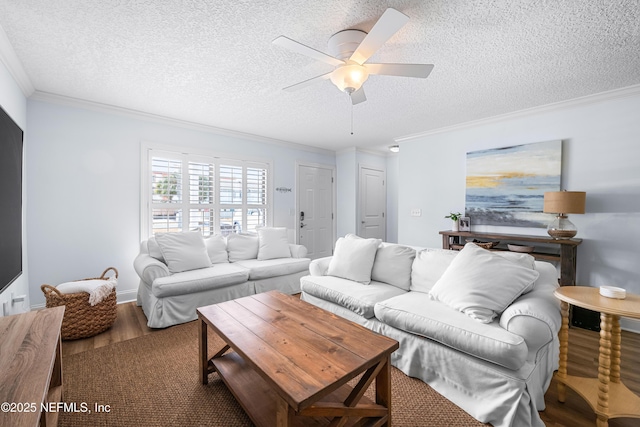 living room with ornamental molding, a ceiling fan, a textured ceiling, and wood finished floors