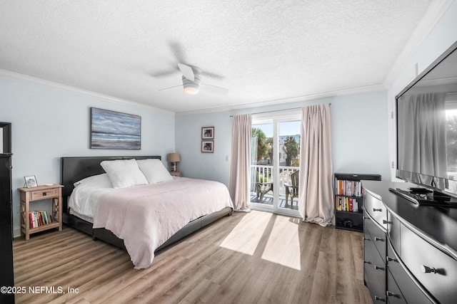 bedroom with a textured ceiling, access to outside, wood finished floors, and crown molding