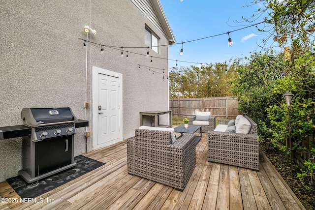 wooden terrace with fence, an outdoor living space, and area for grilling