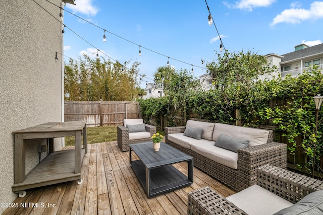 wooden deck featuring a fenced backyard and an outdoor hangout area