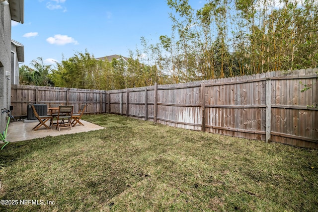 view of yard featuring a fenced backyard, a patio, and central air condition unit