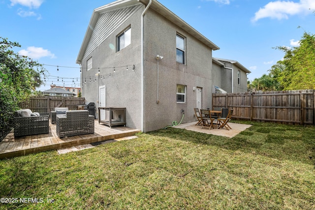 rear view of house featuring a patio, a fenced backyard, an outdoor living space, a yard, and stucco siding