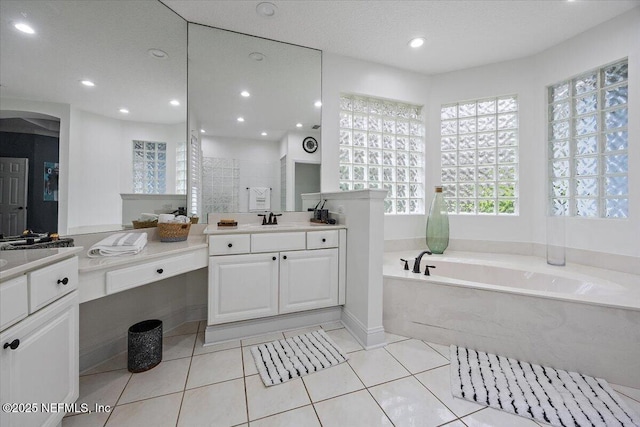 full bath with recessed lighting, vanity, a bath, and tile patterned floors