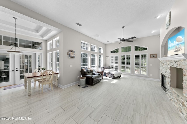 sunroom / solarium with ceiling fan, a fireplace, and visible vents