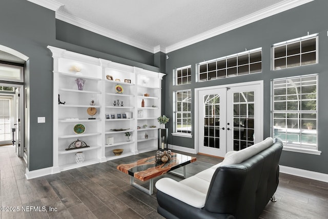 sitting room featuring dark wood-style floors, french doors, ornamental molding, and baseboards