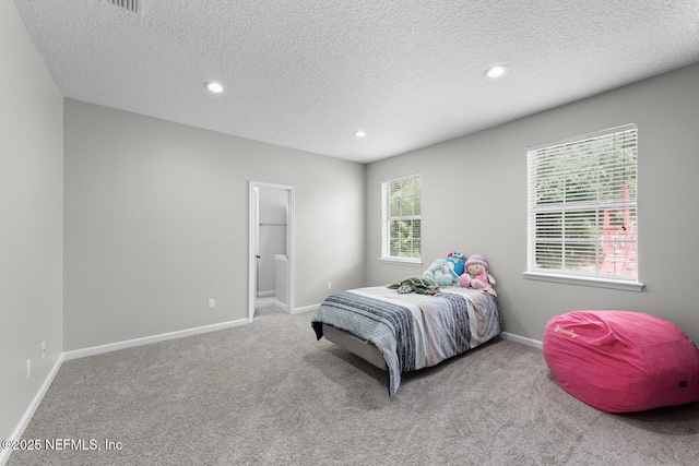 bedroom featuring a textured ceiling, recessed lighting, light colored carpet, and baseboards