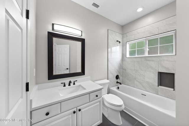 bathroom with shower / tub combination, toilet, vanity, visible vents, and tile patterned floors