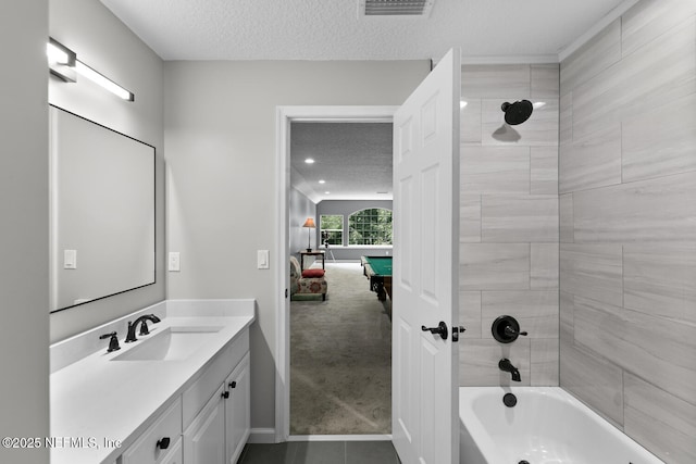 ensuite bathroom featuring billiards, visible vents,  shower combination, a textured ceiling, and vanity