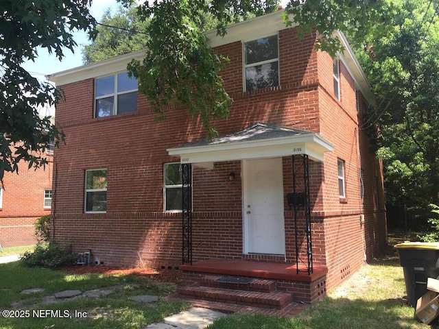 view of front of house featuring brick siding