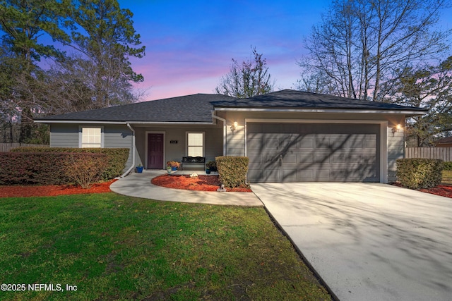 single story home with an attached garage, a front lawn, and concrete driveway