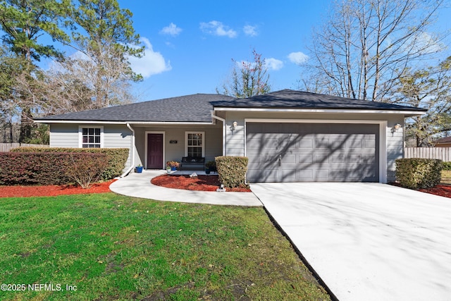 single story home featuring a garage, fence, concrete driveway, and a front yard