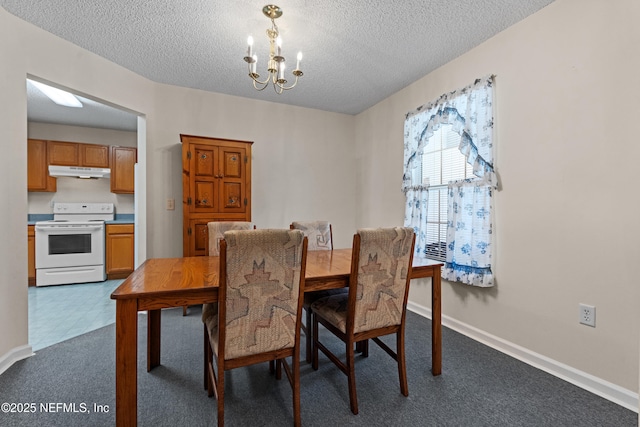 dining area with a textured ceiling, dark carpet, baseboards, and a notable chandelier