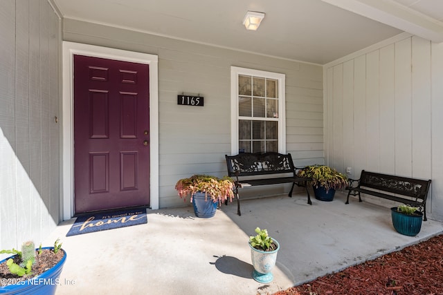 view of exterior entry featuring a patio area