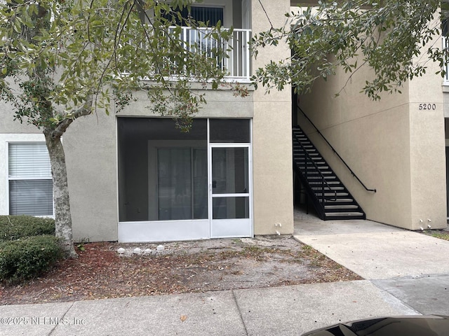 doorway to property with stucco siding