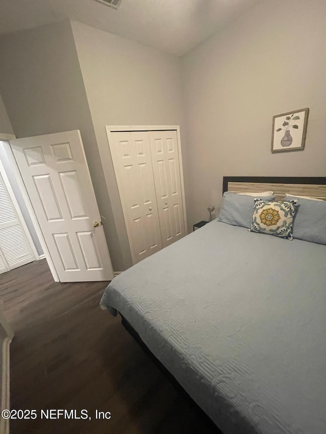 bedroom featuring a closet and dark wood-type flooring