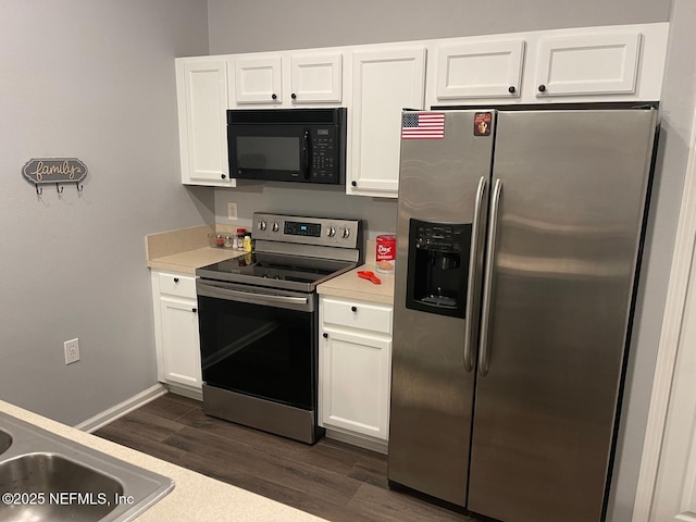 kitchen with appliances with stainless steel finishes, light countertops, dark wood-type flooring, and white cabinetry