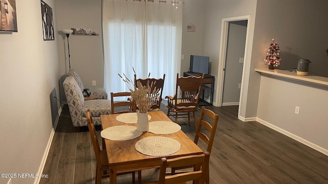 dining area featuring wood finished floors and baseboards