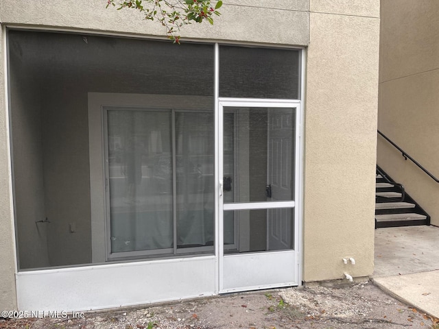 doorway to property with stucco siding