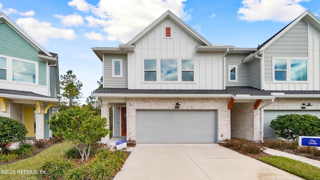 multi unit property featuring driveway, a garage, a shingled roof, board and batten siding, and brick siding