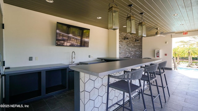 view of patio / terrace with outdoor wet bar, ceiling fan, and a sink