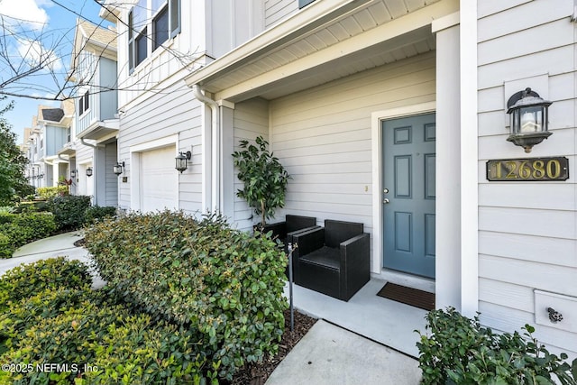 property entrance featuring an attached garage and board and batten siding