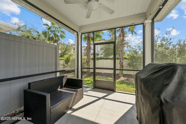 sunroom / solarium featuring ceiling fan