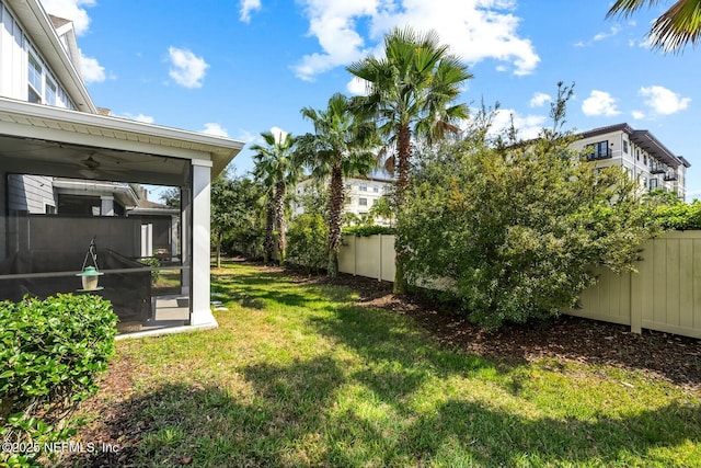 view of yard with a fenced backyard and a sunroom