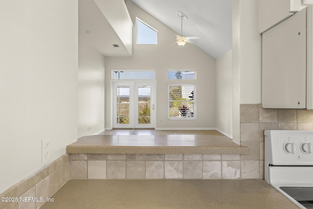 180 Kingston Dr, Saint Augustine, FL 32084 - kitchen featuring visible vents, white cabinets, ceiling fan, stove, and lofted ceiling