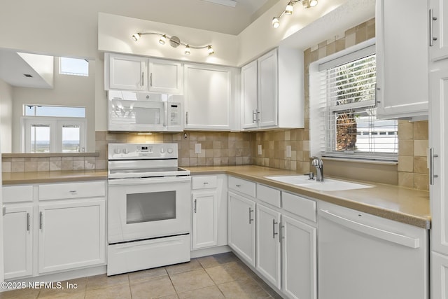 180 Kingston Dr, Saint Augustine, FL 32084 - kitchen featuring tasteful backsplash, white cabinetry, a sink, and white appliances