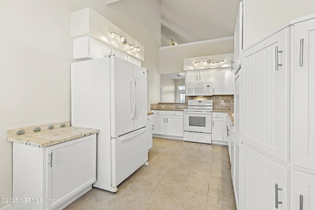 180 Kingston Dr, Saint Augustine, FL 32084 - kitchen featuring white appliances, light tile patterned floors, light countertops, white cabinets, and decorative backsplash