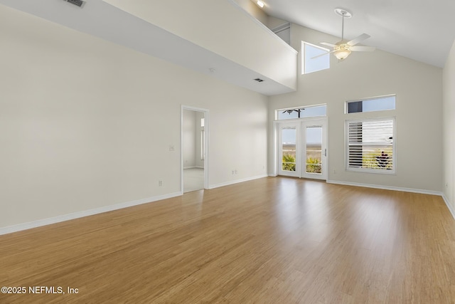 180 Kingston Dr, Saint Augustine, FL 32084 - unfurnished living room with ceiling fan, high vaulted ceiling, light wood-style floors, and baseboards
