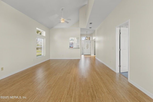 180 Kingston Dr, Saint Augustine, FL 32084 - unfurnished living room with light wood-style flooring, baseboards, a ceiling fan, and vaulted ceiling