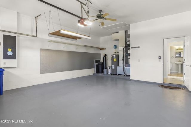 180 Kingston Dr, Saint Augustine, FL 32084 - garage with ceiling fan, electric panel, water heater, a sink, and a garage door opener