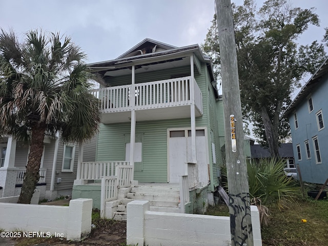 multi unit property featuring covered porch and a balcony