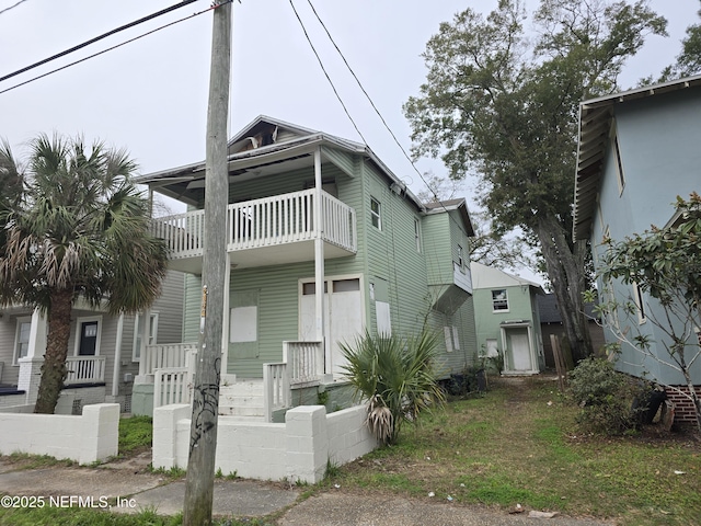 townhome / multi-family property featuring a balcony and covered porch