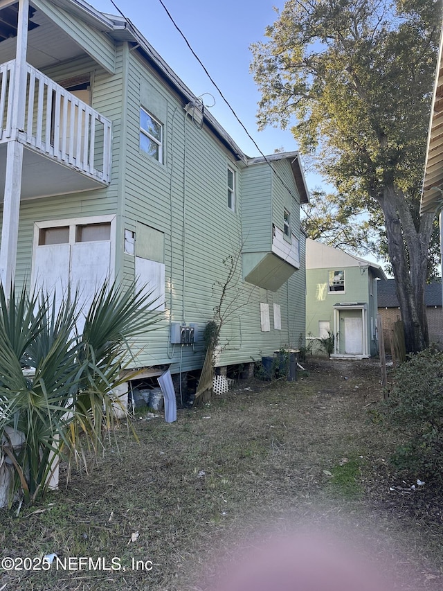 view of side of home with a balcony